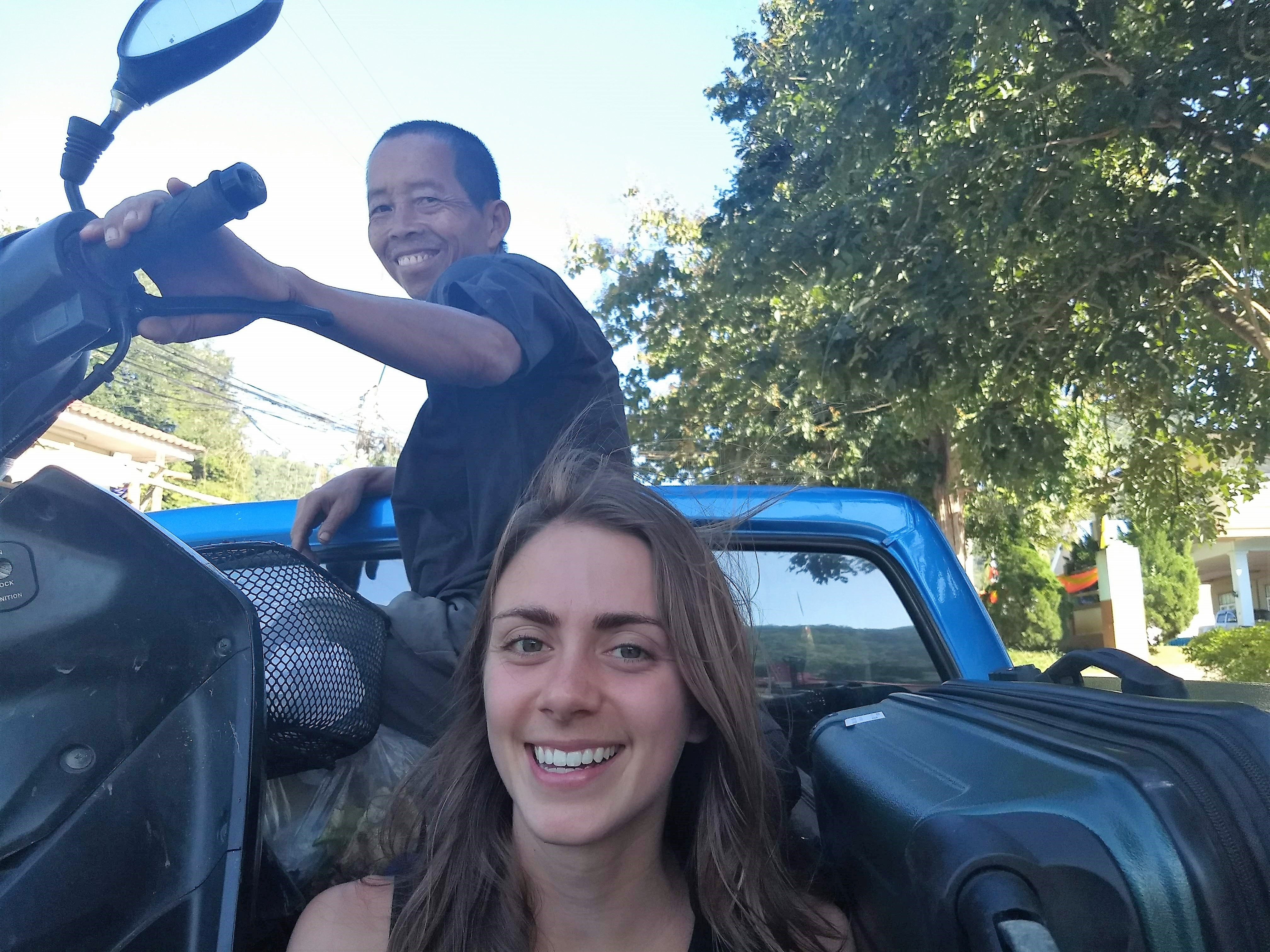 Alana (center) and Pi Nan traveling between the two Mindful Farms in the back of a truck.