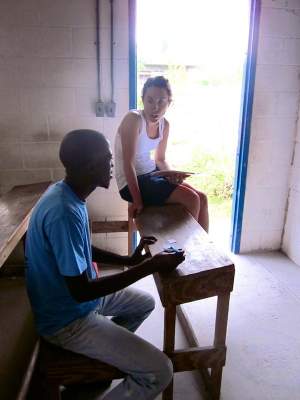 Natalie explains the difference between comparatives and superlatives to Robinson, one of her students, in beginner English class.