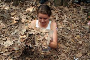 Judi enters the Cu Chi tunnels in Vietnam.